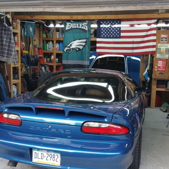 Organized Garage With Blue Camaro, Storage Shelves, and Flags - LSX427f1 from Drexel Hill, Pennsylvania