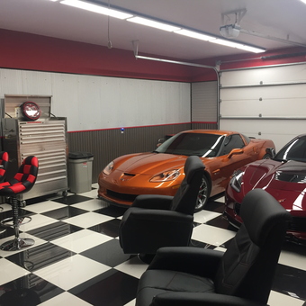 Modern garage with Corvettes, tool chest, and checkered floor - Rusty from Casper, Wyoming