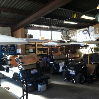Golf cart repair garage with storage shelves and tools - Golf cart guy