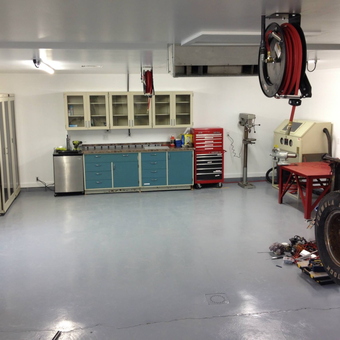 Organized garage with cabinets, tool chest, and hose reel - i c e b l u e from Peoria, Illinois