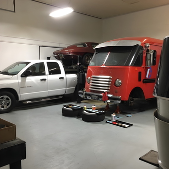Organized garage with lift, classic cars, and tools - Shadow 13 from Pasadena, California
