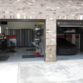 Organized garage with storage cabinets and car lift - David from Charlotte, NC