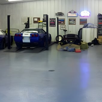 Organized garage with blue Corvettes and car lift - Roger from Delano, Mn