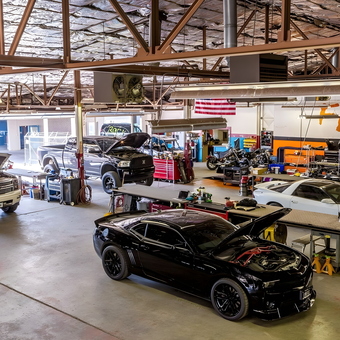 Spacious auto garage with cars, tool chests, and workbenches - F/X Motor Sports from Amarillo, TX