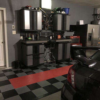Organized garage with cabinets, tool chest, and checkered floor - JJUDJR from Van Alstyne, TX