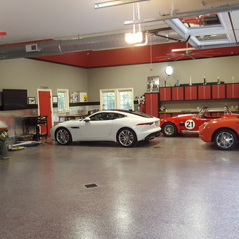 Luxury Garage with Red Cabinets, Tool Storage, and Classic Cars - Anonymous