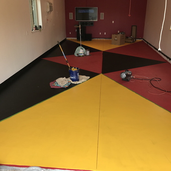 Garage With Bold Red Yellow Black Epoxy Floor Coating