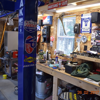 Organized garage workbench with car lift and wall signs - Paul from Augusta, Maine