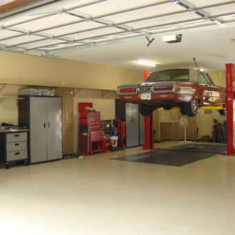 Organized garage with car lift, tool cabinets, and storage - Larry from Dallas, TX