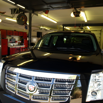 Organized garage with red cabinets and Cadillac - Michael from Newburgh, IN