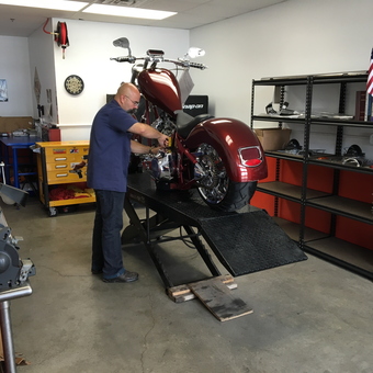 Organized garage with motorcycle lift and tool storage - CAT BILER from HENDERSON, NV