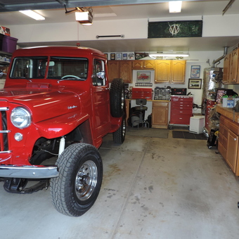 Organized garage with red Willys truck and tool cabinets - Willys from Flagstaff, AZ