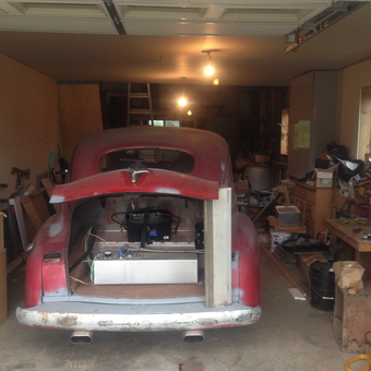 Classic car restoration garage with tools and boxes - Dodge Dreamer from Clinton, New York