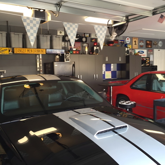 Organized Garage with Cabinets, Metal Storage, and Classic Cars - Anonymous