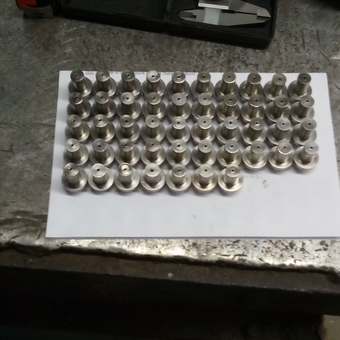 Machined Metal Parts on Workbench - Lane Manufacturing from Los Lunas, New Mexico