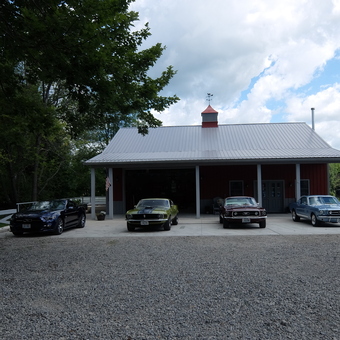 Classic Mustang Collection in Front of Red Garage - Bruno's from Lowellville, Ohio