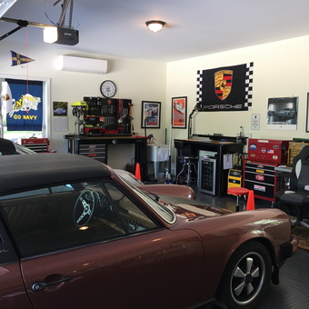 Organized garage with Porsche decor, tool chests, and workbench - Dave from Gurley, AL