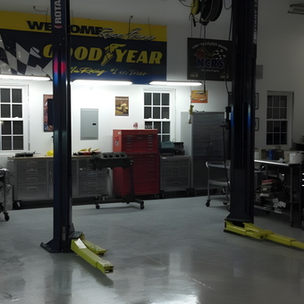Spacious garage with lifts, tool chests, and banners - GarageMahal from Nevada, Iowa
