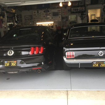 Garage with Two Black Ford Mustangs and Wall Decor - Chris