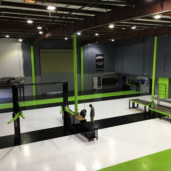 Modern garage with car lift, workbenches, and storage - Shanon Parker from Port Canaveral, Fl