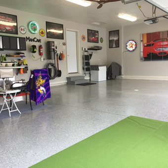 Organized garage with wall art, cabinets, and neon signs - Daniel from South Dakota