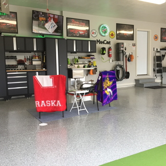 Organized garage with cabinets, wall decor, and seating - Daniel from South Dakota