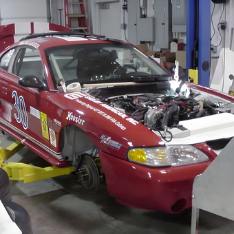 Race car on lift with tools and parts in garage - Keith from Saint Louis, MO