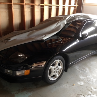 Black sports car with cover in unfinished garage - Zed from Milton, Ontario