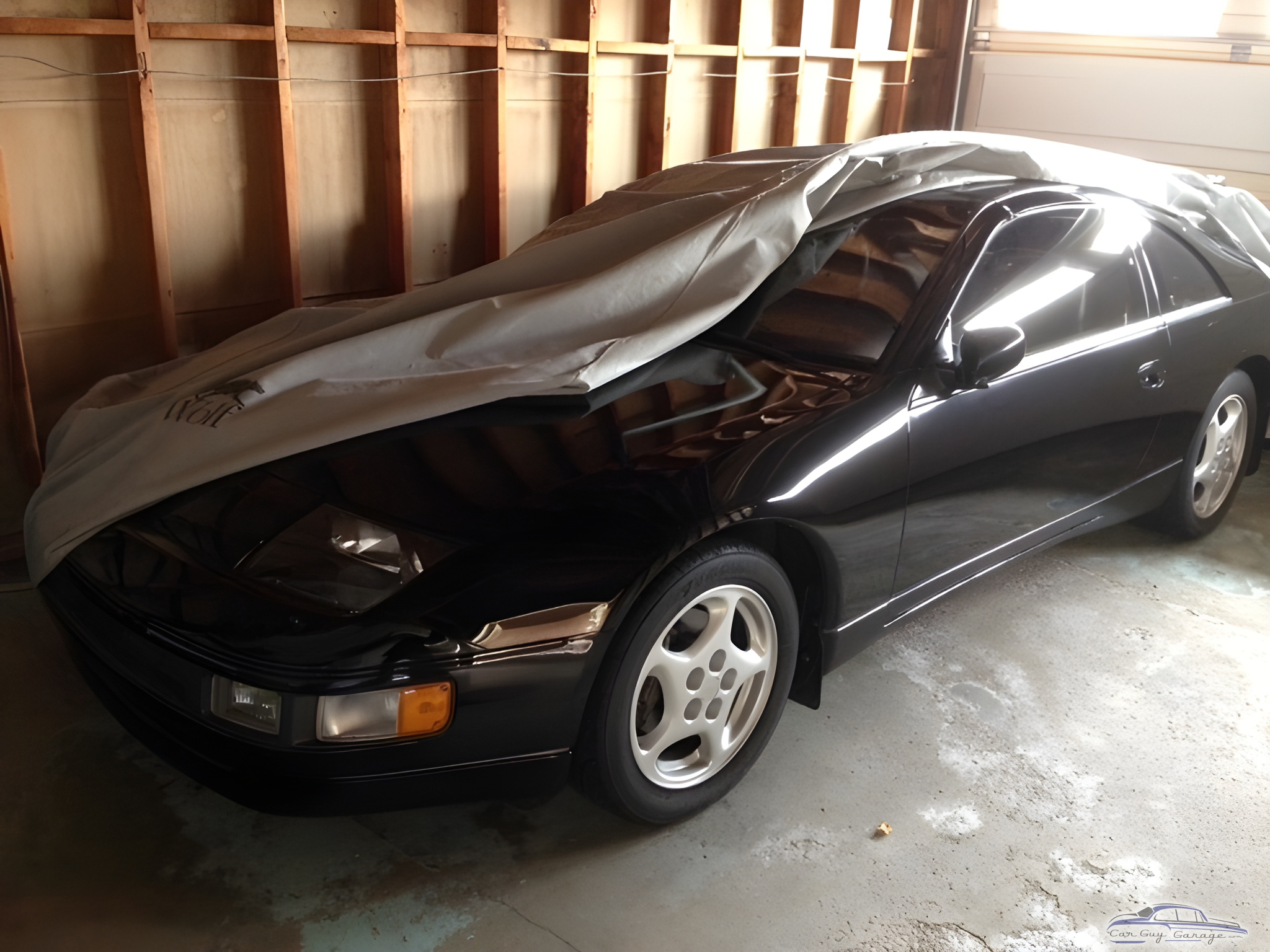 Black sports car with cover in unfinished garage - Zed from Milton, Ontario