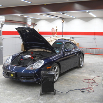 Modern garage with sports car, lighting, tool cart, and curtains - Z