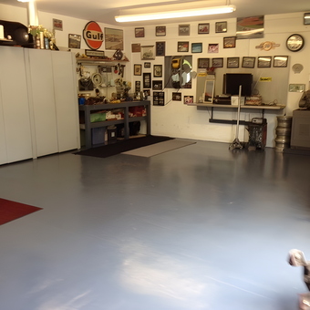 Organized garage with cabinets, workbench, and wall decor - Bugattiboy from Port Charlotte, FL