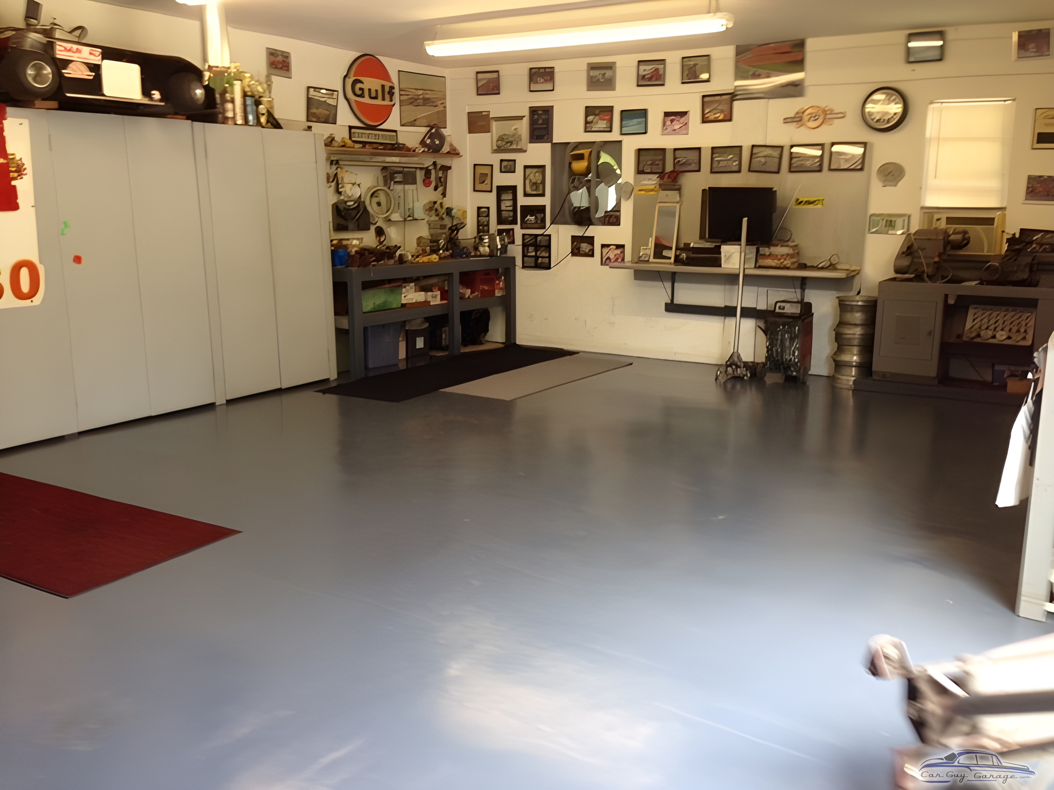 Organized garage with cabinets, workbench, and wall decor - Bugattiboy from Port Charlotte, FL