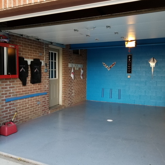 Organized garage with wall cabinets and Corvette decor - Paula from Crescent, PA