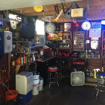 Organized garage with wall cabinets, stools, and neon signs - Max from Elkhorn, WI
