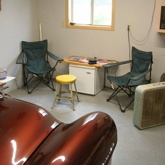 Garage Lounge Area with Chairs, Fan, and Fridge - Art from Reading, Michigan