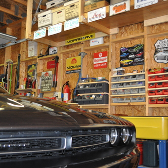 Classic car garage with Mopar signs and storage bins - Mikey