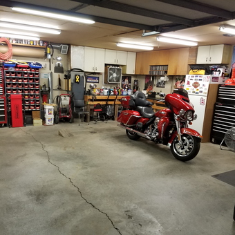 Organized garage with red tool cabinets and motorcycle - Van from Galesburg, Illinois