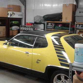 Organized garage with yellow classic car and storage shelves - 440 Mopar Satellite from Wichita Falls, TX
