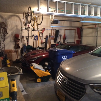 Organized garage with bike racks, ladder storage, and wall hooks - Kai from Davenport, IA