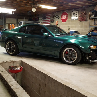 Garage with Mustang, street signs, shelving - Matt mccartan from COLORADO SPGS, Colorado