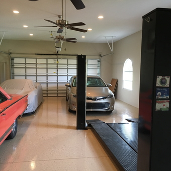 Spacious garage with car lift, ceiling fans, and epoxy floor - Joe from Punta Gorda, Florida
