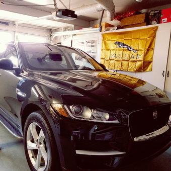 Jaguar SUV in Clean Garage with Cabinets and Banner - RJC Garage from Hayward, CA