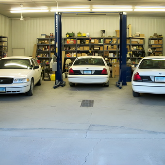 Organized garage with car lifts, shelving, and three vehicles - Keith from Cummings, ND