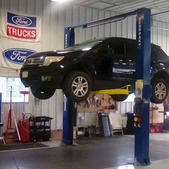 Garage with Car Lift, Tool Chest, and Ford Signs - Tovar from Cheshire, Mass.