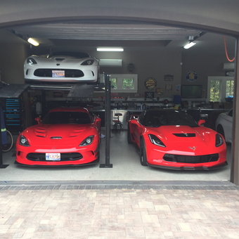 Garage with Car Lift, Tool Cabinets, Red Sports Cars - Anonymous