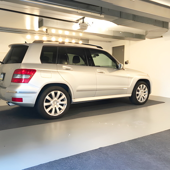 Clean garage with silver SUV and wall-mounted EV charger - Bob from Clairton, PA