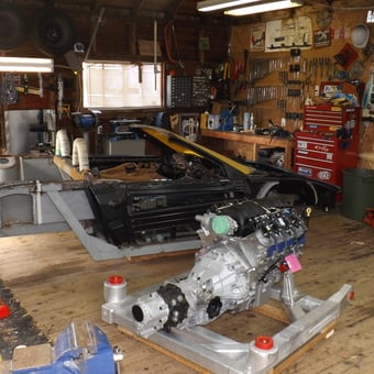 Organized garage with car chassis, tools, and engine - Graham from Yarmouth, Nova Scotia