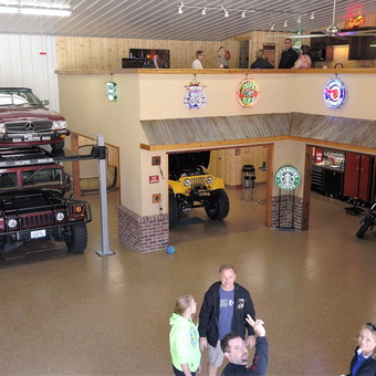 Custom garage with car lift, neon signs, and classic vehicles - Steve from Shoreview, MN