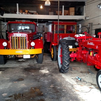 Classic Autocar Trucks and Farmall Tractor in Garage - John D from Clifton, NJ