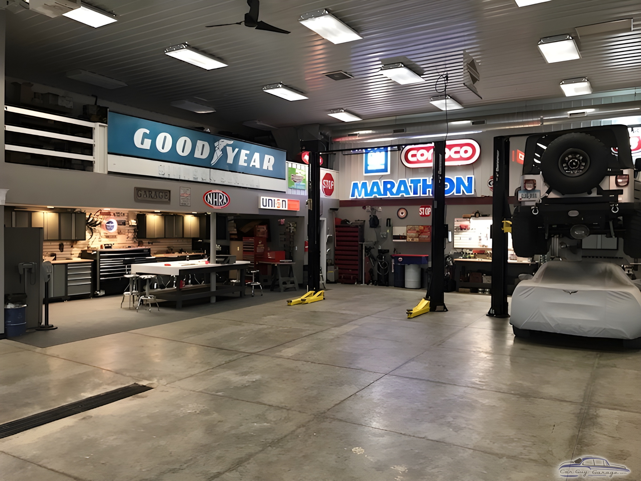 Spacious garage with lifts, workbenches, and vintage signs - Rob from Center Point, Iowa